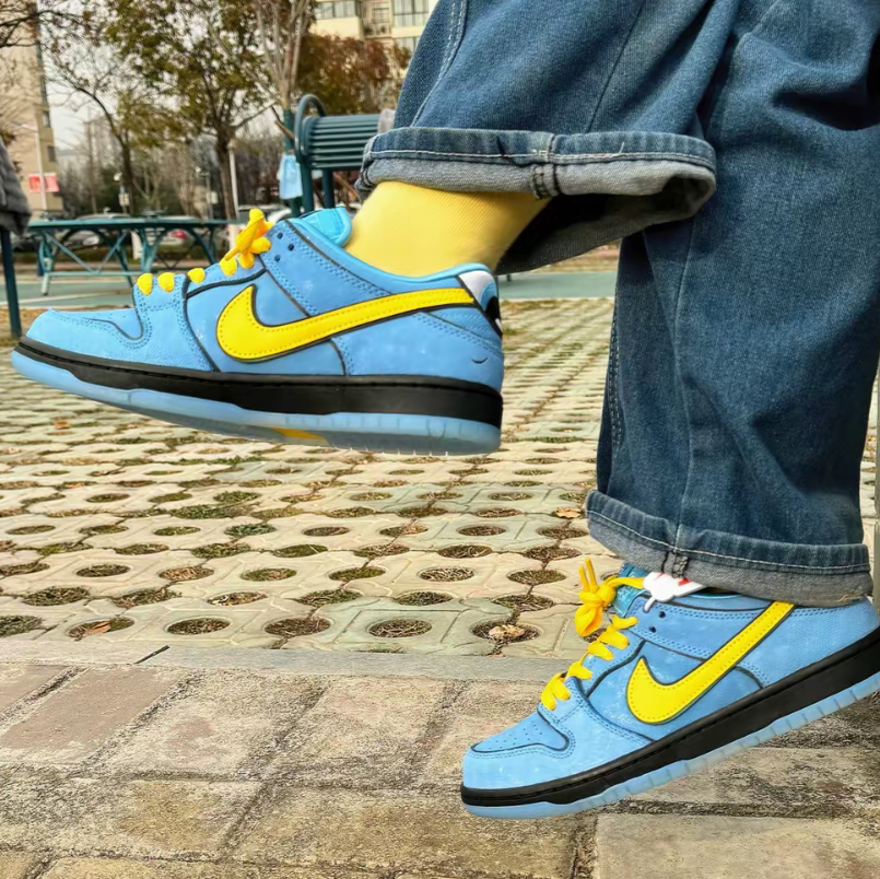 Tênis Nike Azul Dunk Low Meninas Super Poderosas Lindinha Visto no Pe Junto com Meia Amarela e Calca Jeans
